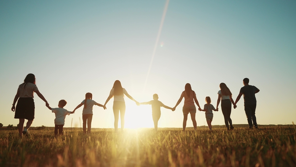 People walking into sunset together